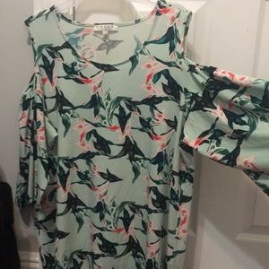 A light green blouse with pink flowers